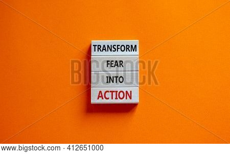 Transform Fear Into Action Symbol. Businessman Holds Wooden Blocks With Words 'transform Fear Into A