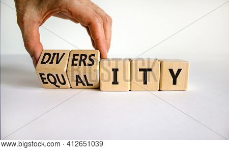 Diversity And Equality Symbol. Businessman Turns Wooden Cubes, Changes The Word 'equality' To 'diver
