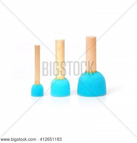 Blue Sponges On A Wooden Handles Isolated On White Background