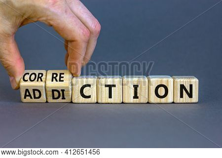 Correction Addiction Symbol. Businessman Turns Wooden Cubes And Changes The Word 'addiction' To 'cor