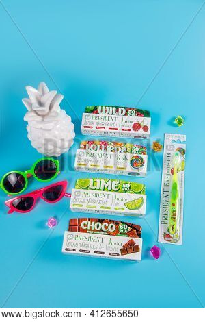 Moscow, Russia - 9th Matra 2021: Childrens Toothpastes And A Toothbrush On A Blue Background.the Con