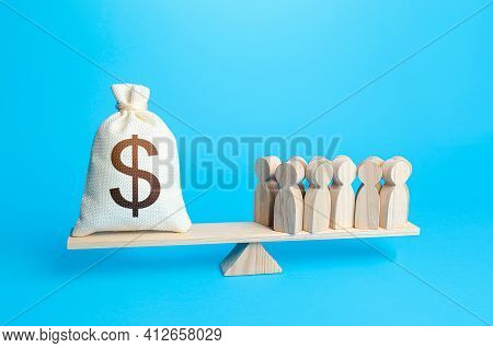 Group Of People And Dollar Money Bag On Weight Scales. Required Payment Of Staff Salaries. Staff Mai