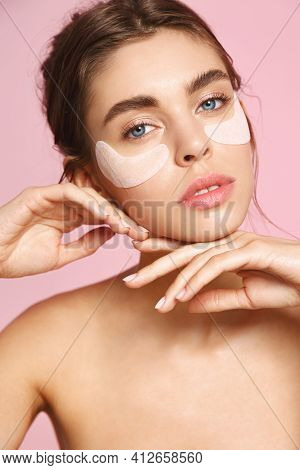 Sensual Woman With Naked Body And No Makeup, Natural Face, Using Under Eye Paches For Skin Nourishme