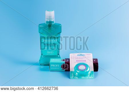 Moscow, Russia - 9 Matra 2021: Mouthwash, Toothpaste And Dental Floss On A Blue Background.the Conce