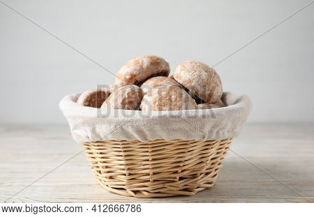Tasty Homemade Gingerbread Cookies In Basket On White Wooden Table