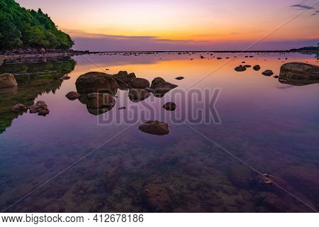 Long Exposure Image Of Dramatic Sky Seascape With Rock In Sunset Scenery Background.beautiful Sunris