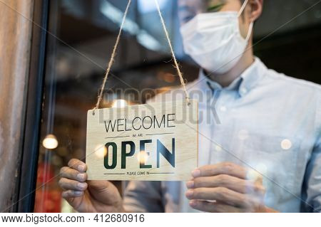 Cafe Or Restaurant And Business Reopen After Coronavirus Quarantine Is Over. Man With Face Mask Turn