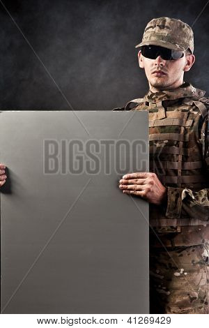 Modern Soldier Is Holding A Poster