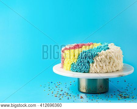 Shag Cake On Blue Background. Colorful Vanilla Shag Cake With Perfect Vanilla Buttercream. Idea Of V