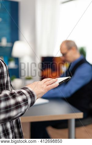 Close Up Of Senior Woman Hand Scrolling On Digital Device In Home. Close Up Of Elderly Woman Using M