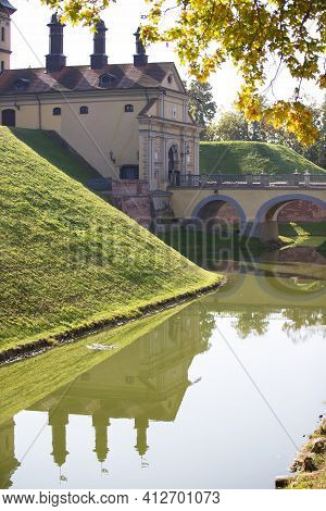 Part Of An Old Castle On A Background Of A Green Swamp Vertically Architectural Retro Building.