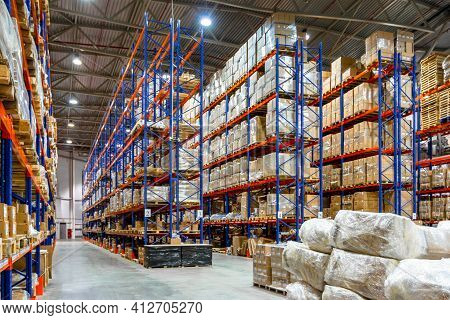 Interior Of A Modern Warehouse Storage Of Retail Shop With Pallet Truck Near Shelves