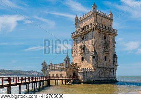 Scenic Belem Tower And Wooden Bridge Miroring With Low Tides On Tagus River. Torre De Belem Is Unesc