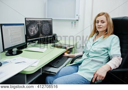 Medical Theme. Doctor In The Mri Office At Diagnostic Center In Hospital, Sitting Near Monitors Of C