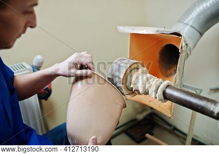 Prosthetist Man Making Prosthetic Leg While Working In Laboratory.