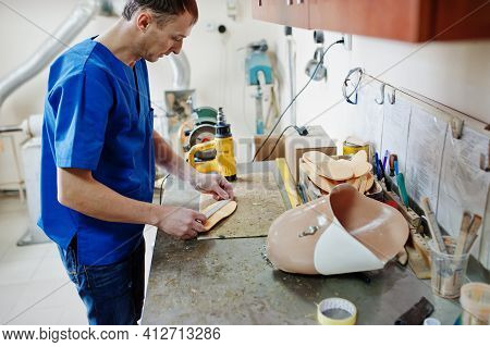 Prosthetist Man Making Orthopedic Insoles While Working In Laboratory.