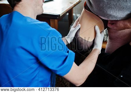 The Prosthetist Removes The Measure From A Person With A Disability, Woman With Amputee.