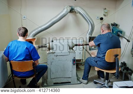 Two Prosthetist Man Workers Making Prosthetic Leg While Working In Laboratory.