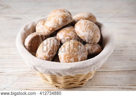 Tasty Homemade Gingerbread Cookies In Basket On White Wooden Table