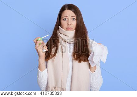 Attractive Sick Dark Haired Woman Don't Want To Use Spray To Treat Sore Throat, Looking Tired And Fe