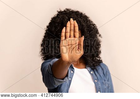 African American Woman Hiding Behind Her Palm