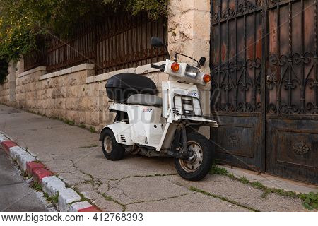 Jerusalem, Israel, February 27, 2021 : Evening View Of An Old Small Scooter Standing On Benjamin Dis