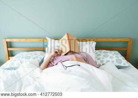 Asian Handsome Man Read Books While Sleeping. Man Book Cover Drowsiness Causes Sleep.the Concept Of 