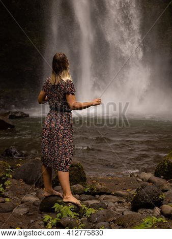 Caucasian Woman Enjoying Waterfall Landscape. Nature And Environment Concept. Travel Lifestyle. Woma