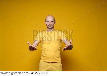 Handsome, Benevolent Caucasian Man Stands With His Arms Outstretched, Ready For A Hug And A Welcome.