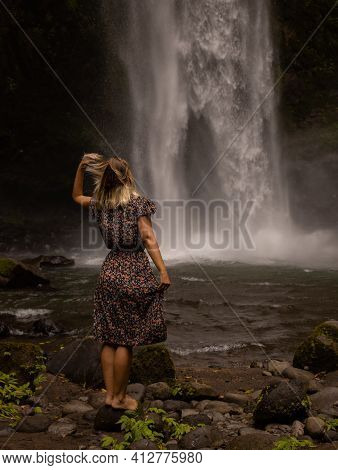 Caucasian Woman Enjoying Waterfall Landscape. Nature And Environment Concept. Travel Lifestyle. Woma