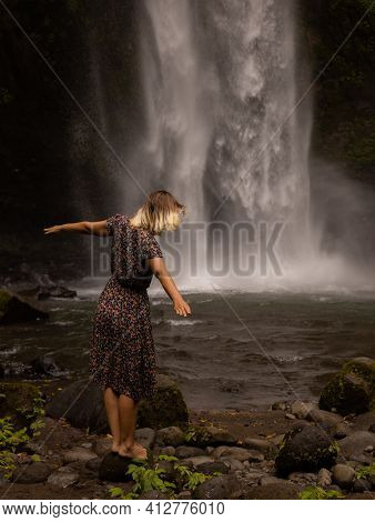 Caucasian Woman Enjoying Waterfall Landscape. Nature And Environment Concept. Travel Lifestyle. Woma