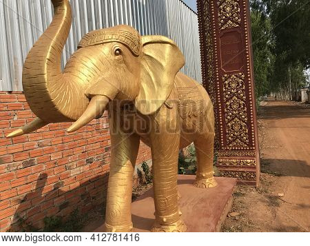 Kampong Spue, Cambodia, March 16, 2021:the Golden Elephant Is Beautiful In Front Of The Gate.