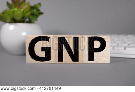 Gnp. Text On Wood Cubes. Text In Black Letters On Wood Blocks