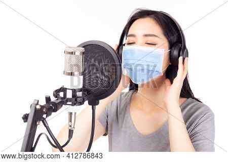 Portrait Young Asian Woman Recording Song In A Recording Studio. Singer Female Performing And Singin