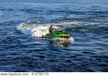 Kherson, Ukraine - July 22, 2020: An Adult Man Rides A Jet Ski On The Dnieper River In Kherson (ukra