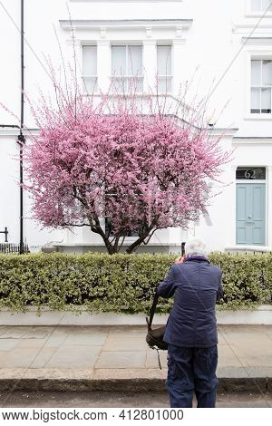 Portland Road, Notting Hill, London, England, United Kingdom - March 05 2021 Elderly Taking A Photo 