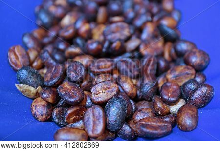 Closeup Of Heap Of Black Honey Process Coffee Beans