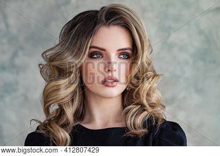 Lovely Woman Model With Curly Hairstyle On Gray Background Portrait