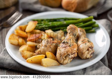 Roast Chicken With Potatoes And Asparagus. High Quality Photo.