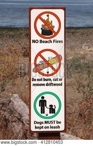 View Of Warning Sign No Beach Fires, Do Not Burn, Cut Or Remove Driftwood, Dogs Must Be Kept On Leas