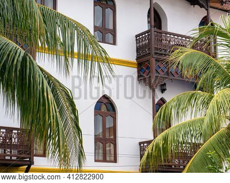 White Building Fascade With Palms In Stone Town, Zanzibar