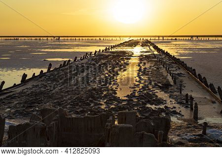 Golden  Sunset Over Syvash Lake. Salt Lake With Healing Mud In The Rays Of The Setting Sun. Beautifu
