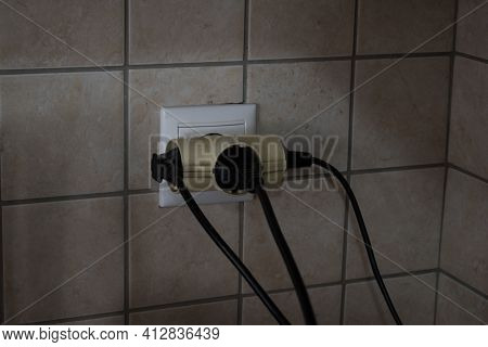 Overloaded Outlet With An Extension And Many Sockets Plugged In, Risk Of Fire And Short Circuit On A