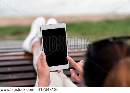 Top View Mockup Image Of Woman S Hands Holding And Using Black Tablet Pc With Blank White Desktop Sc