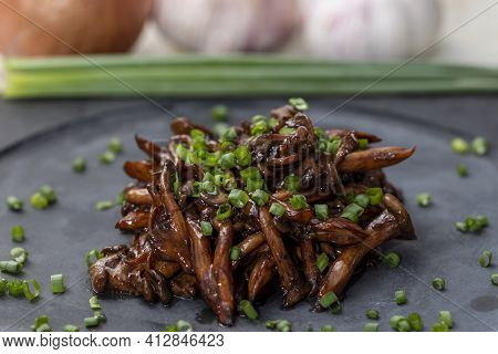 Shimeji Mushroom Served With Chives On Black Stone Plate. Typical Oriental Meal. Detail Of Food Dish