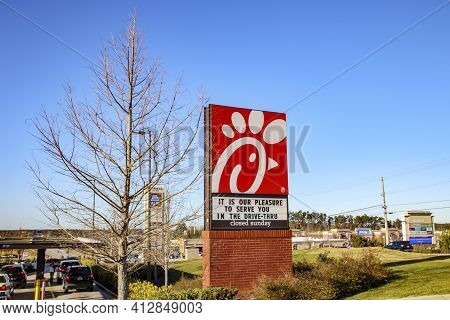 Columbia County, Ga Usa - 02 23 21: Chick Fil A Restaurant Street Sign On A Clear Day And People