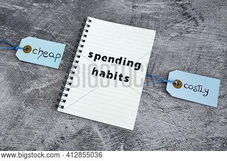 Cheap Vs Costly Prioduct Price Tags Next To Spending Habits Notepad, Money And Consumer Behaviour Co