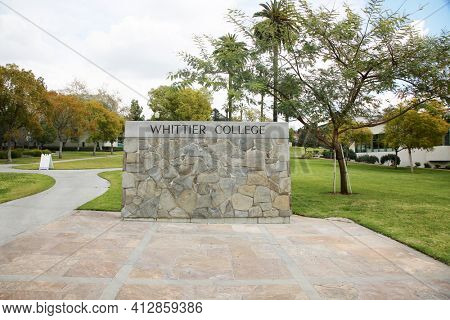 March 12, 2021 - Whittier, California: Whittier College. Large Rock Wall with WHITTIER COLLEGE Sign at the entrance to campus. Closed due to Coronavirus Pandemic. Editorial Use Only. 
