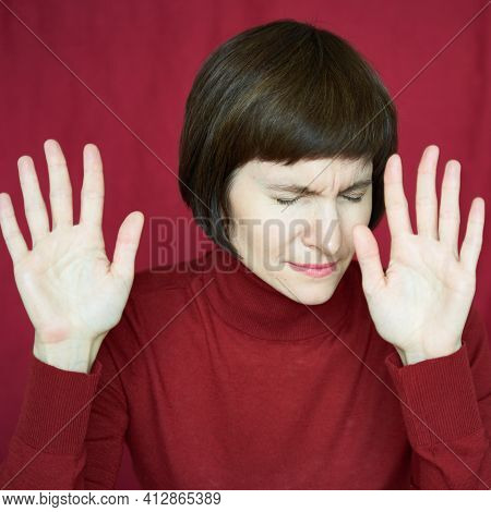 Portrait Of Mature Woman In Distress, Hands Up, Stoping Situation, Stop Gest. Agitated Tensed Face. 
