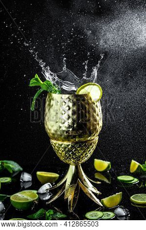 Moscow Mule Cocktail In Copper Cup With Lime, Ginger Beer, Vodka And Mint Garnish. Freeze Motion. Ve